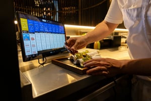 Chef carefully plating a dish in a professional kitchen