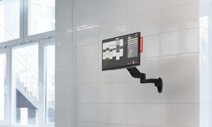 Annoncer Prestige kitchen display mounted on an articulated wall arm in a professional kitchen