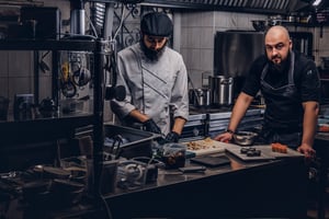Professional kitchen team working to reduce service mistakes with Annoncer