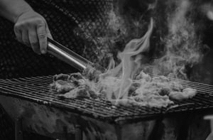 Ingredients being grilled with lots of flames