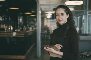 Restaurant manager overseeing service in a busy restaurant