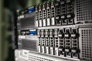 Close up of enterprise rack servers in a modern data center with storage drives and network infrastructure.