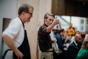 Chef coordinating kitchen communication during a busy restaurant service